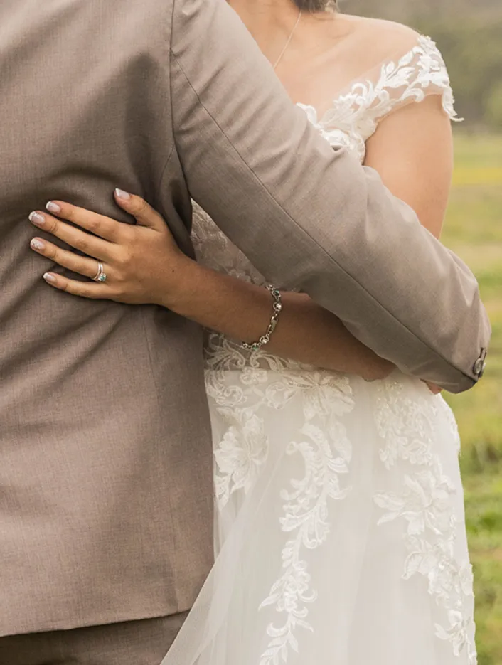 Wedding couple hugging.