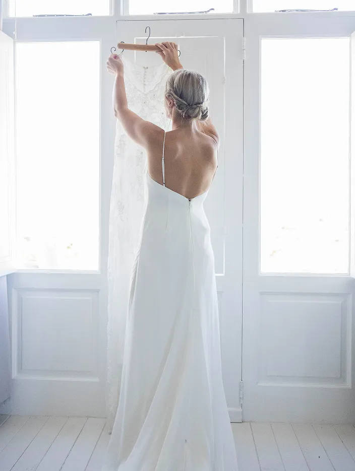 Woman holding a wedding dress. Wedding photography
