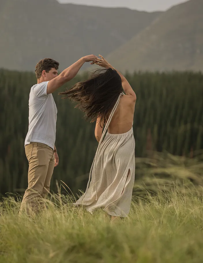 Couple dancing outside on a field