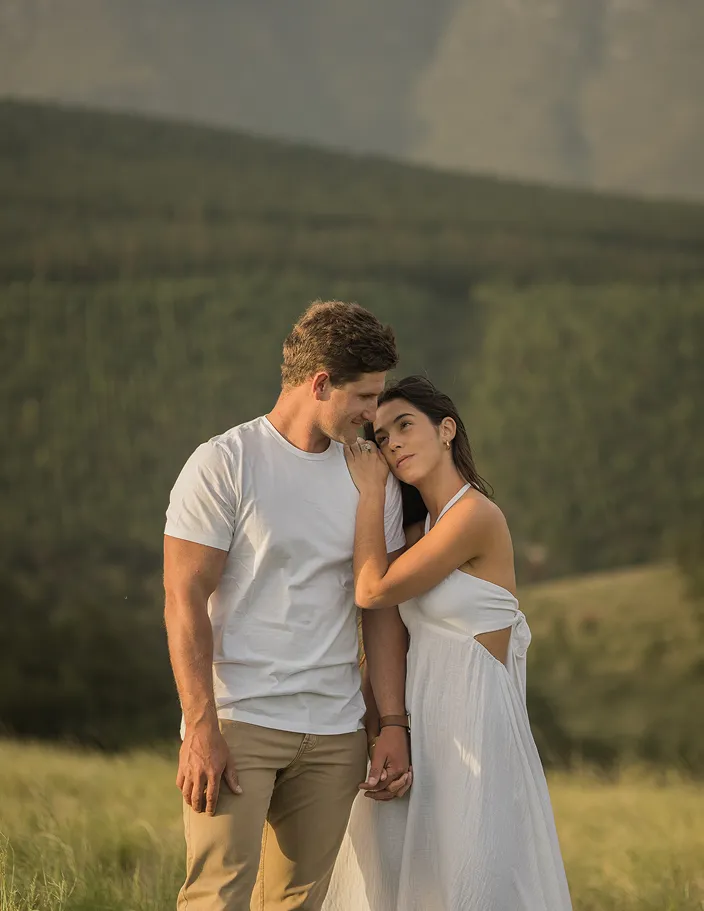 Couple looking at each other in the field.