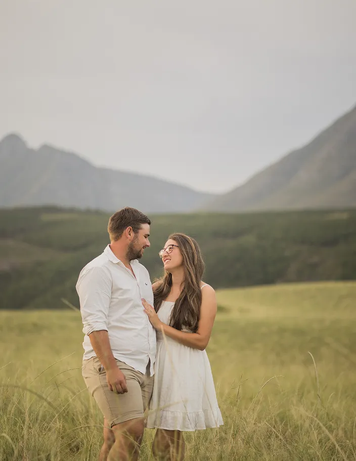 Couple looking at each other in a field