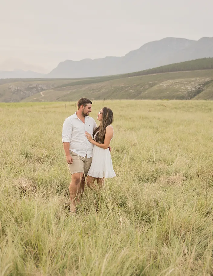 Couple looking at each other in a field