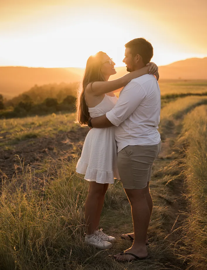 Couple Looking at each other with sunset behind them