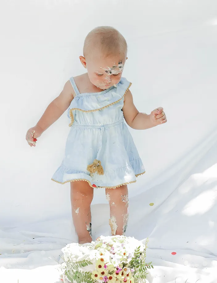 Newborn playing with cake