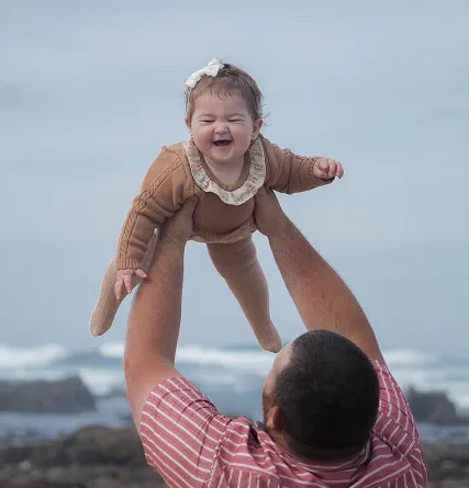 Newborn being held up
