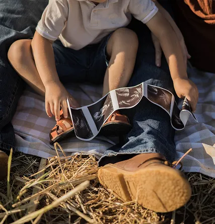 Son looking at maternity with dad