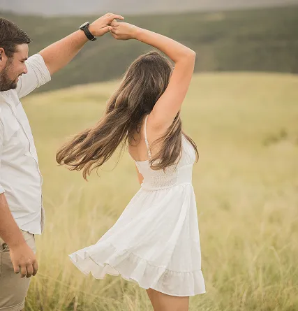 Couple dancing outside on a field