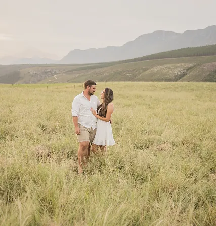 Couple looking at each other in a field